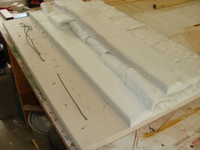 DSC02480.jpg (111.84 KiB) Viewed 49069 times Flipped right side up. The element ends are poking through. The little marks that look like ants are the bent ends of the wires securing the elements. Ceramic fibre blanket covers it and insulates it from the expanded metal lid. The element ends were brought up safely to the connectors in an enclosure on top of the expanded metal lid.